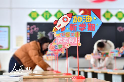 2026年3月2日，在湖北襄阳保康县实验小学，教师正在整理学生课桌上的新教材，认真做好开学前的各项准备工作。杨韬摄（人民图片网）